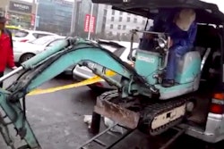 Guy loads excavator into minivan