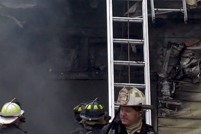 In this still from WRTV footage, the ladder used in the rescue is seen as firefighters investigate the home.