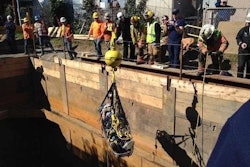 Rescue workers lift the worker from the pit using a crane. Credit: Gladstone Fire Department