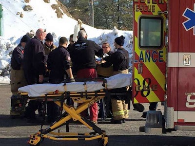 Paramedics secure a construction worker before transport after he fell 15 feet onto rebar. Credit: Rochester Fire Department