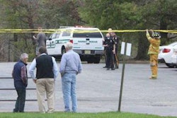 Men look on as law enforcement and fire officials close off the scene of the accident. Credit: Thomas E. Franklin/NorthJersey.com