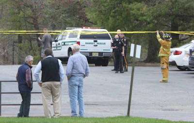 Men look on as law enforcement and fire officials close off the scene of the accident. Credit: Thomas E. Franklin/NorthJersey.com