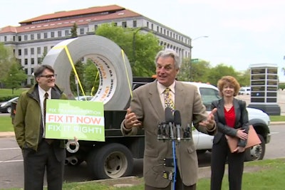 Still from the KARE 11 newscast shows the campaign’s giant roll of duct tape during a stop in St. Paul..