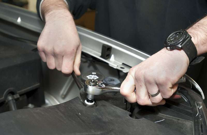 The GM 1500 driver's-sdie fender brace must be unbolted to drop in the auxiliary battery. It's put back after the battery and isolator are in place.