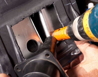 Use hole saw and a vacuum to keep the plastic shavings from getting into the headlight reflector. Note TWO mounting holes.