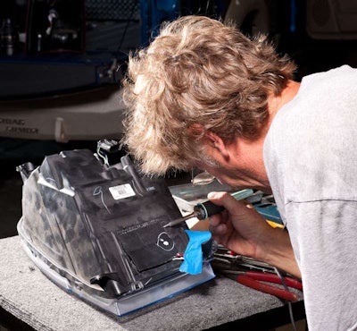 Place the plastic panel you removed earlier back into position. Use a soldering iron to 'weld' it in place.