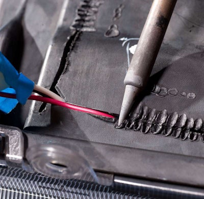 Push the tip of the soldering iron lightly into the plastic so it 'stitches' the two pieces together.