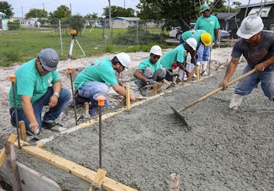 Atlantic High School students at work on a home in Delray Beach. Credit: Lannis Waters / The Palm Beach Post