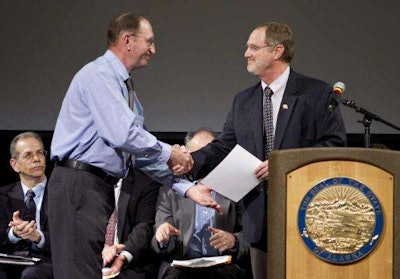 William Giltner receives his award from Steven Hatter, deputy commissioner of ADOT&PF. Photo credit: Michael Penn/Juneau Empire