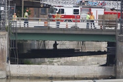 About 6 workers went underneath and harnessed themselves up in a rescue attempt of a worker who fell into the Genesee River on Monday, June 22. (Photo from the Democrat and Chronicle)
