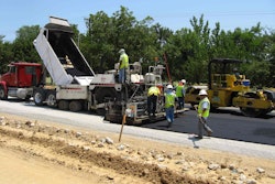 A 1-inch layer of warm-mix asphalt bond breaker being is set down for a Federal Highway Administration Highways for LIFE project in Texas.