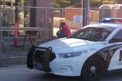 A worker sits following a scaffolding fall that took the life of two co-workers on an Ames jobsite June 19. Photo Credit: Matthew Rezab/Iowa State Daily