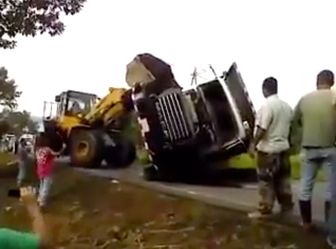Wheel loader uprights truck into jungle