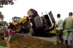 Wheel loader uprights truck into jungle