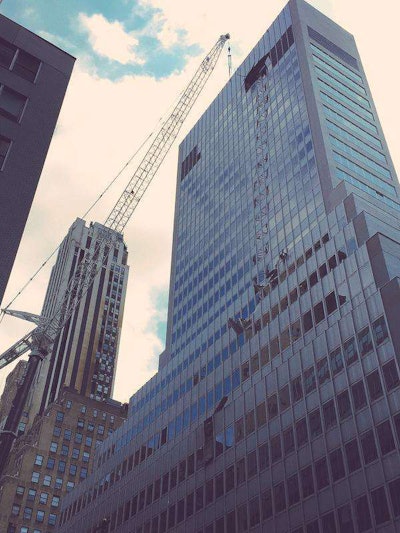 The crane and damaged side of the building in the aftermath of the crash. Credit: @Violetworld via Twitter