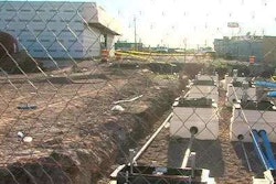 The scene of the trench collapse is seen in a still from KFDA TV footage.