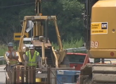 Workers are seen at the site of an embankment and trench collapse near Millville in WBRE news footage.