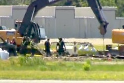 Rescue workers and safety officials are seen examining the site in a still from WTNH footage.