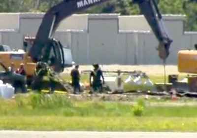 Rescue workers and safety officials are seen examining the site in a still from WTNH footage.