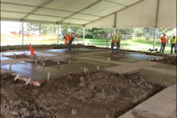 Volunteers formed and placed 1,000 square feet of textured concrete and colored exposed bands. The finish is a combination of a light tan colored concrete with two slightly darker bands running through the slab in a cross design.