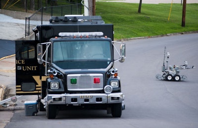 A bomb squad truck and robot arrive at the scene where the device was found. Photo Credit: Daniel Brenner/Columbia Daily Tribune