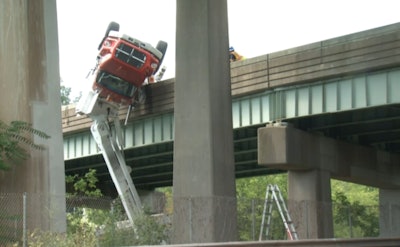 The snooper truck that killed a bridge inspector in Connecticut hangs over the Interstate 84 on-ramp. (Screenshot from NBC Connecticut)