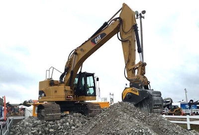 A Cat excavator equipped with an MB Crusher bucket operates during a demonstration at ICUEE 2015.