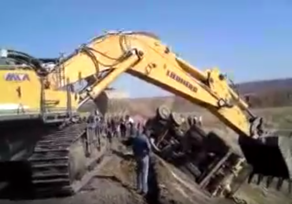 excavator rescues truck from grade mining