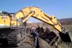 excavator rescues truck from grade mining