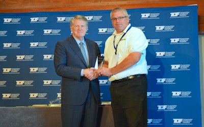 Leo Vecellio (left), ARTBA Transportation Development Foundation chairman, presents Chris Burns, director of safety and administration, Hardman Construction with a Construction Safety Award.