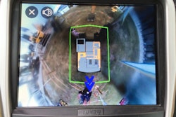 Hyundai CE’s Corey Rogers demos the All Around View Monitoring system’s alerts with a wave from behind the machine.