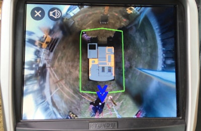 Hyundai CE’s Corey Rogers demos the All Around View Monitoring system’s alerts with a wave from behind the machine.