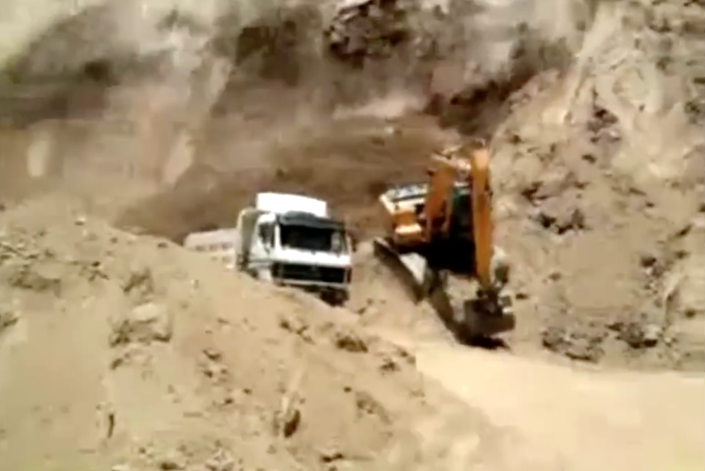 excavator outruns hillside collapse
