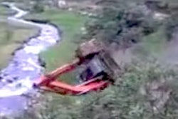 Excavator rolls into creek