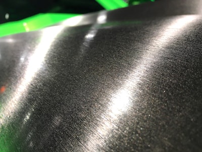 A close-up of that brushed steel vinyl wrap.