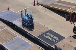 A scissor lift loads itself onto a truck at a United Rentals yard using autonomous technology developed by 5D Robotics.