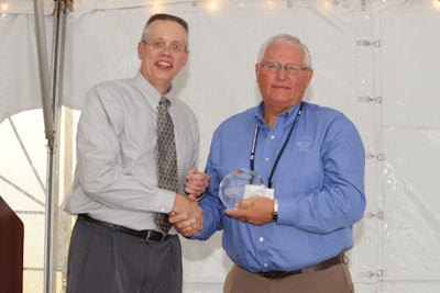 Voigt (left) presenting Larry Engbrecht with the ACPA Outstanding Pavement Promotion Award.