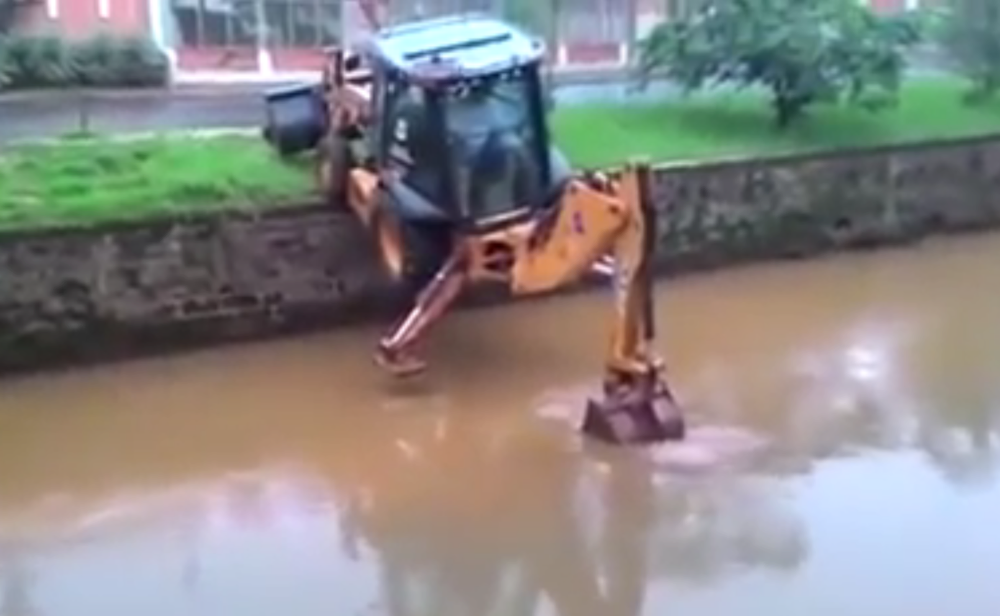 Backhoe waddles through water