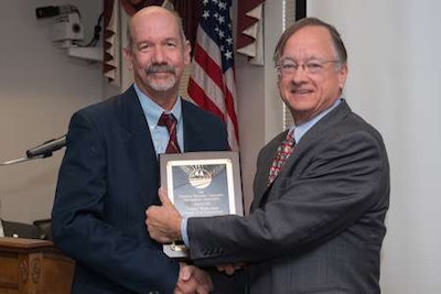 NCDOT Secretary Nick Tennyson (right) presents the NRVMA Turney Hernandez Award of Excellence to Roadside Environmental Engineer Ken Taffer.