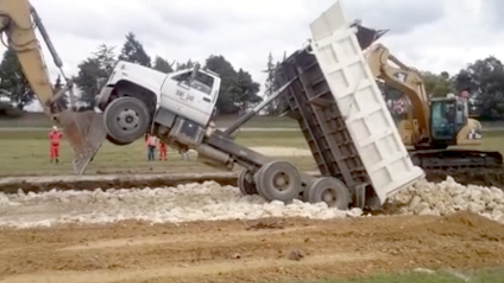 Excavators upright end dump