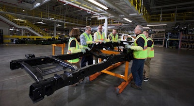 Ford’s five blue collar customers inspect a Super Duty frame at its Dearborn Truck Plant.