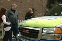Nineteen-year-old Charlotte Heffelmire, shown here to the left of her father, is credited for saving her dad’s life after she lifted this GMC truck off of him during a botched repair job that set the family’s Virginia home on fire.