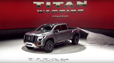 Titan Warrior won a tug of war contest–at least briefly–with a stage hand this week at the Detroit Auto Show. The truck’s reveal cover is shown here stuck on the corner of the truck bed.