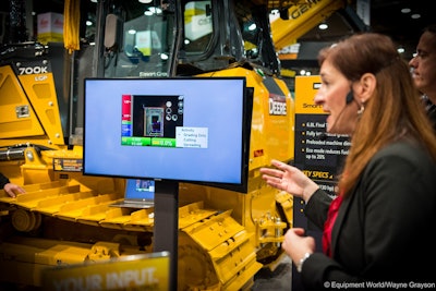 Deere’s Liz Quinn, foreground, gives an overview of SmartGrade features during a World of Concrete 2016 press event.