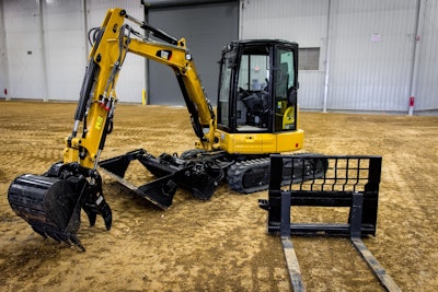 The 304.5E2 equipped with Cat’s MP bucket and a fork in the foreground. Photo credit: Wayne Grayson