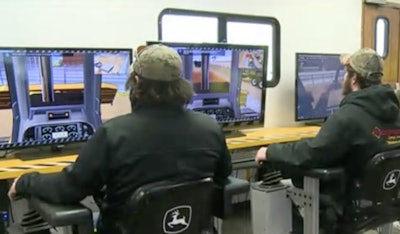 Students work with Deere equipment simulators in Mason City, Ia. Photo credit: KIMT TV footage