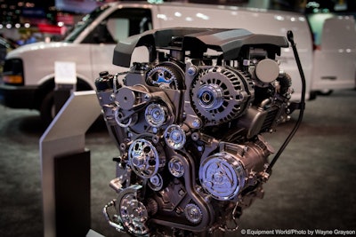 A 2.8L Duramax sits in front of an Express van at Chevy’s Work Truck Show booth.