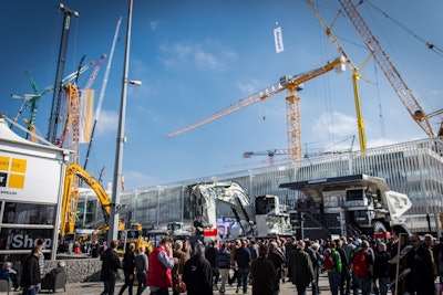 Attendees walk near the Liebherr booth at bauma 2016.