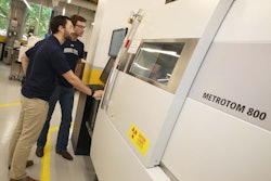 Clayton Greer (front) is the graduate student working on the design of the excavator boom and bucket. He and James Collins, an undergraduate research assistant, are pictured working with a micro-computed tomography machine. Photo credit: Georgia Institute of Technology