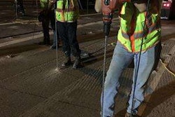 Workers drilling holes at foam injects sites.